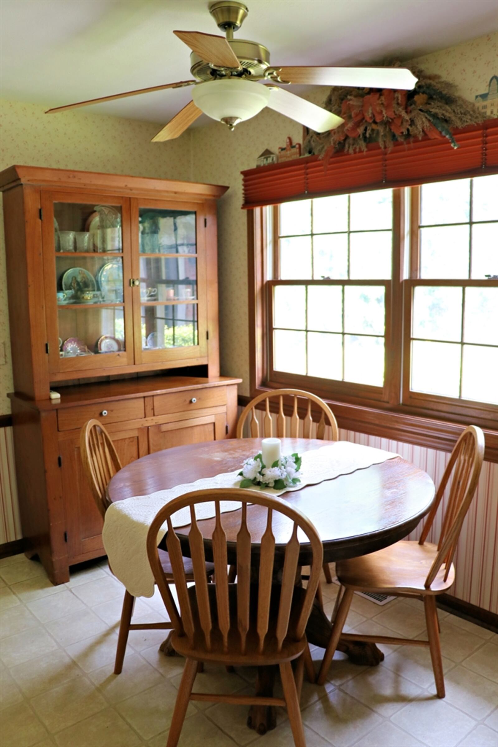 The breakfast room has a picture window that looks out over the backyard.