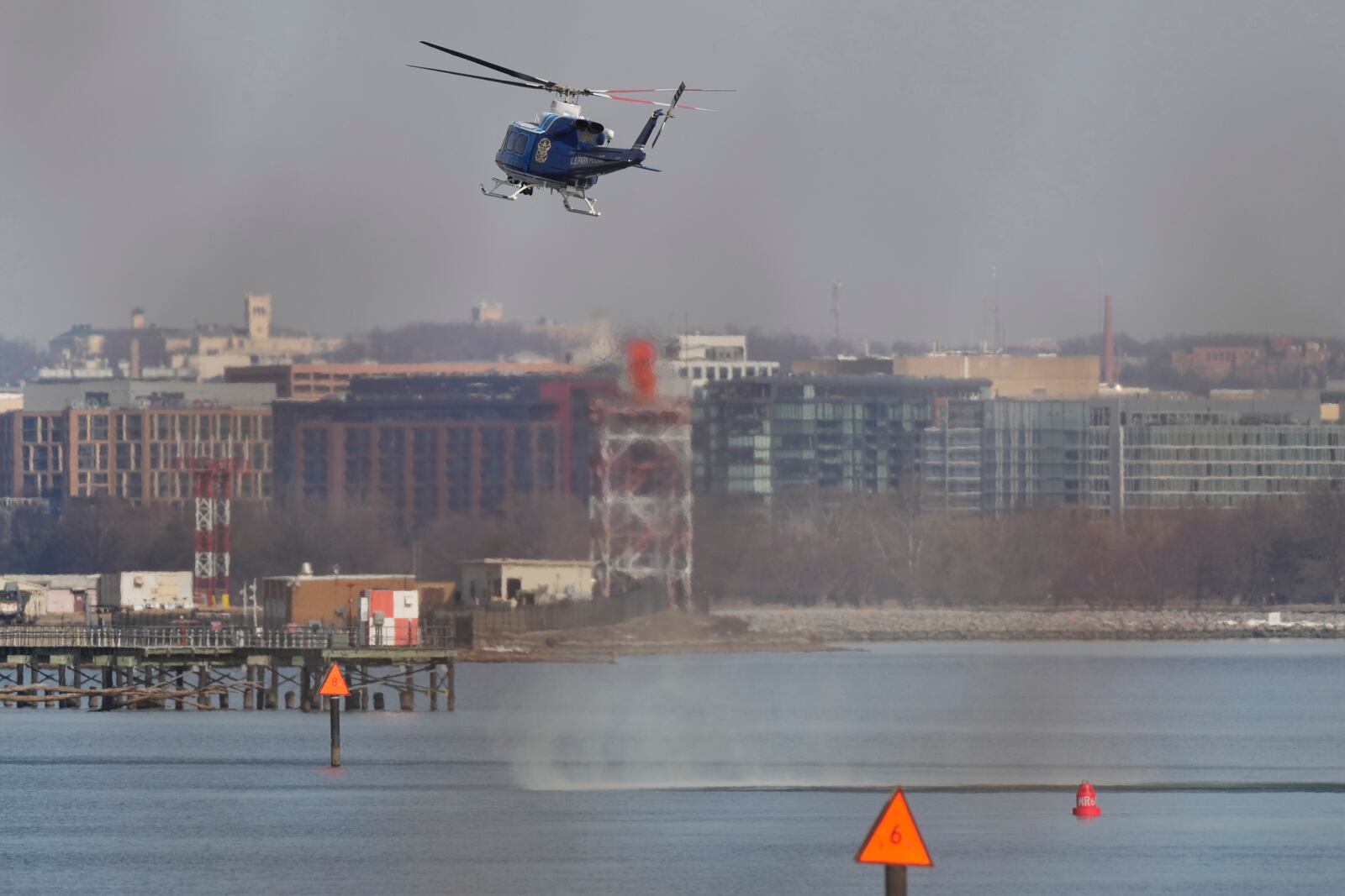 US Park Police helicopter during search and rescue efforts around a wreckage site in the Potomac River from Ronald Reagan Washington National Airport, early Thursday morning, Jan. 30, 2025, in Arlington, Va. (AP Photo/Carolyn Kaster)