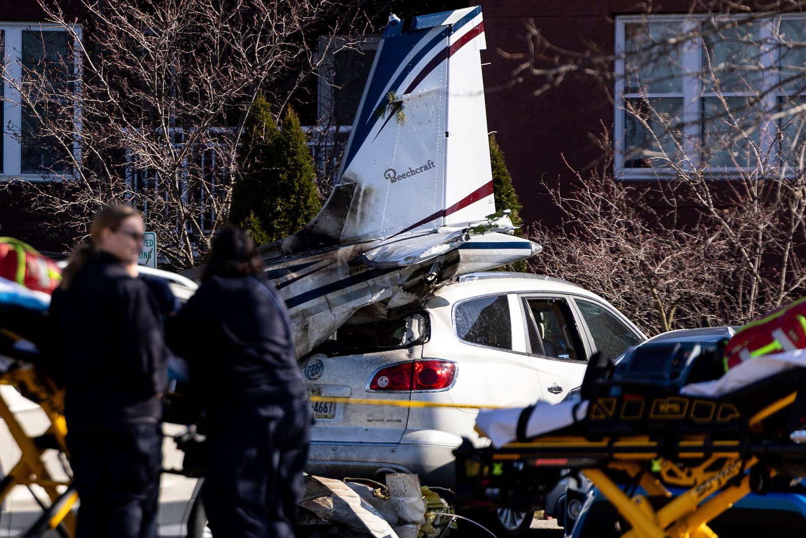 First responders work the scene after a plane crashed in the parking lot of a retirement community in Manheim Township, Pa., Sunday, March 9, 2025. (Logan Gehman/LNP/LancasterOnline via AP)