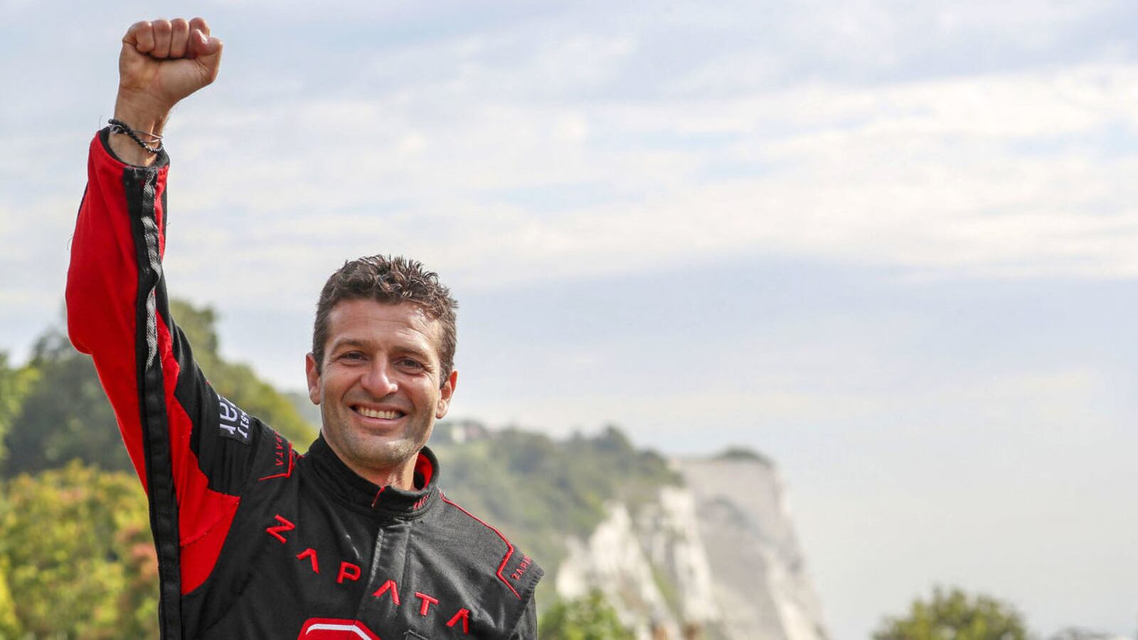 French inventor Frank Zapata raises his fist in victory after successfully crossing the English Channel between France and the United Kingdom on his jet-powered hoverboard Sunday Aug. 4, 2019. He failed during an earlier attempt in late July.