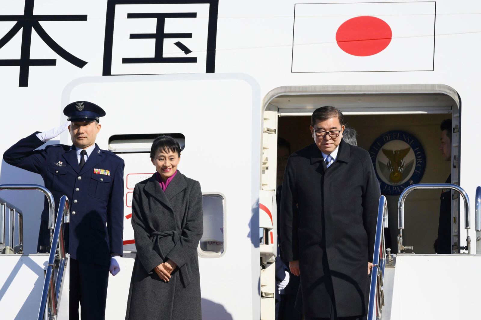 Japanese Prime Minister Shigeru Ishiba, right, with his wife Yoshiko, center, departs for Malaysia and Indonesia, at the airport in Tokyo, Thursday, Jan. 9, 2025. (Kyodo News via AP)