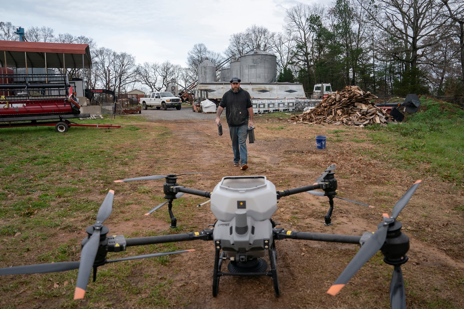 Russell Hedrick prepares a DJI drone to put crop cover on his farm, Tuesday, Dec. 17, 2024, in Hickory, N.C. (AP Photo/Allison Joyce)