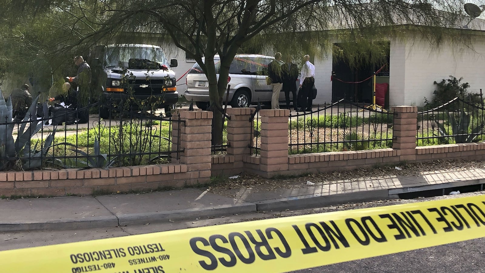 Phoenix fire and police investigators work Wednesday, Jan. 29, 2020, outside the home of Rafael and Maribel Loera. The couple are charged with concealing their dead 11-year-old daughter’s body in their attic for more than two years and abusing their surviving children.