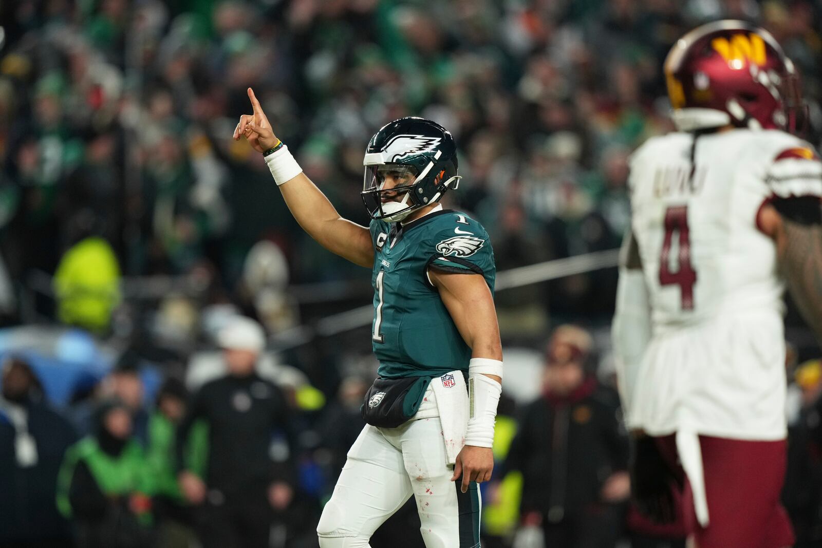 Philadelphia Eagles' Jalen Hurts (1) celebrates a touchdown by Saquon Barkley during the second half of the NFC Championship NFL football game against the Washington Commanders, Sunday, Jan. 26, 2025, in Philadelphia. (AP Photo/Matt Slocum)