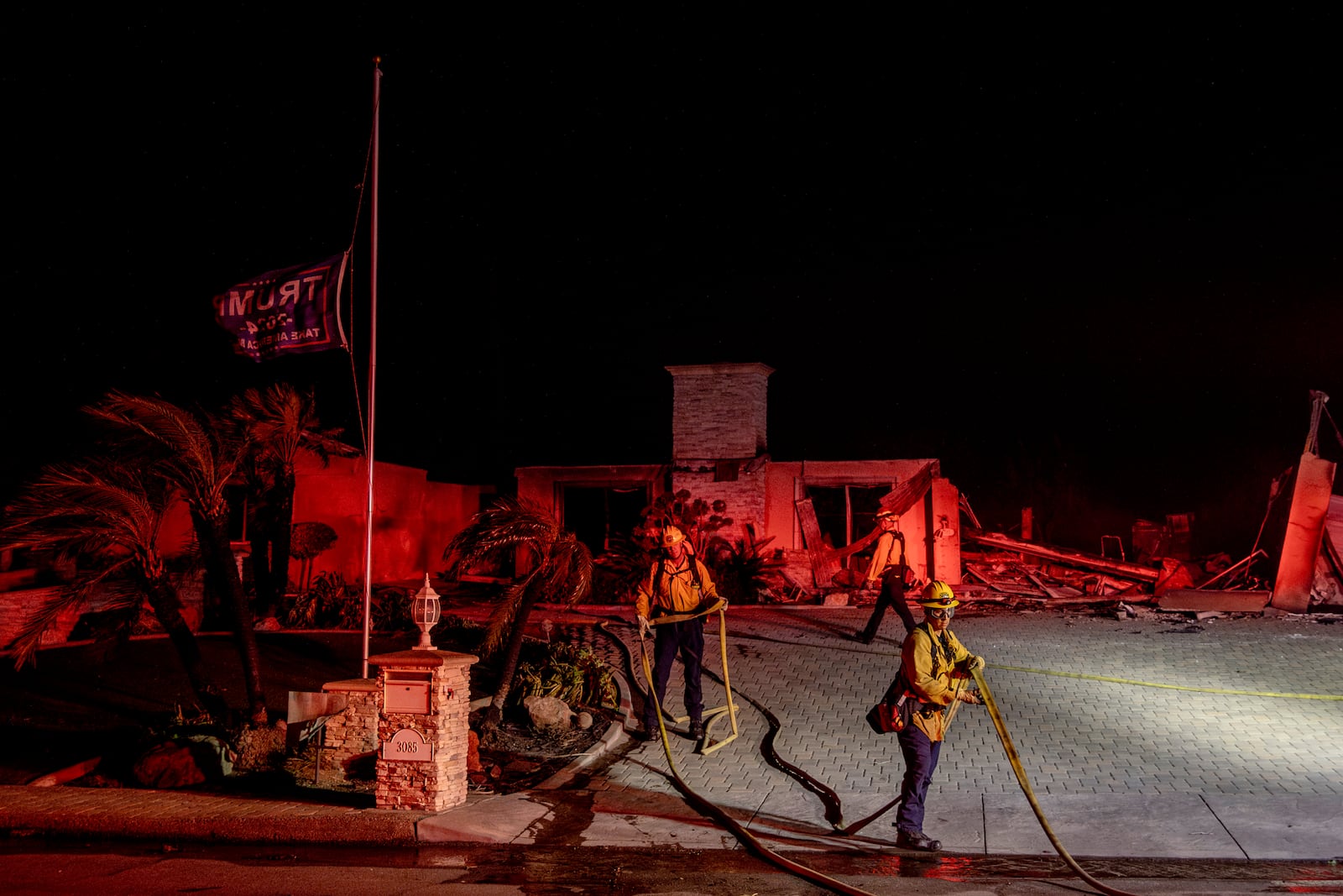 Firefighters with the Culver City Fire Department extinguish hot spots at a home destroyed by the Mountain Fire in Camarillo, Calif., Wednesday, Nov. 6, 2024. (Stephen Lam/San Francisco Chronicle via AP)