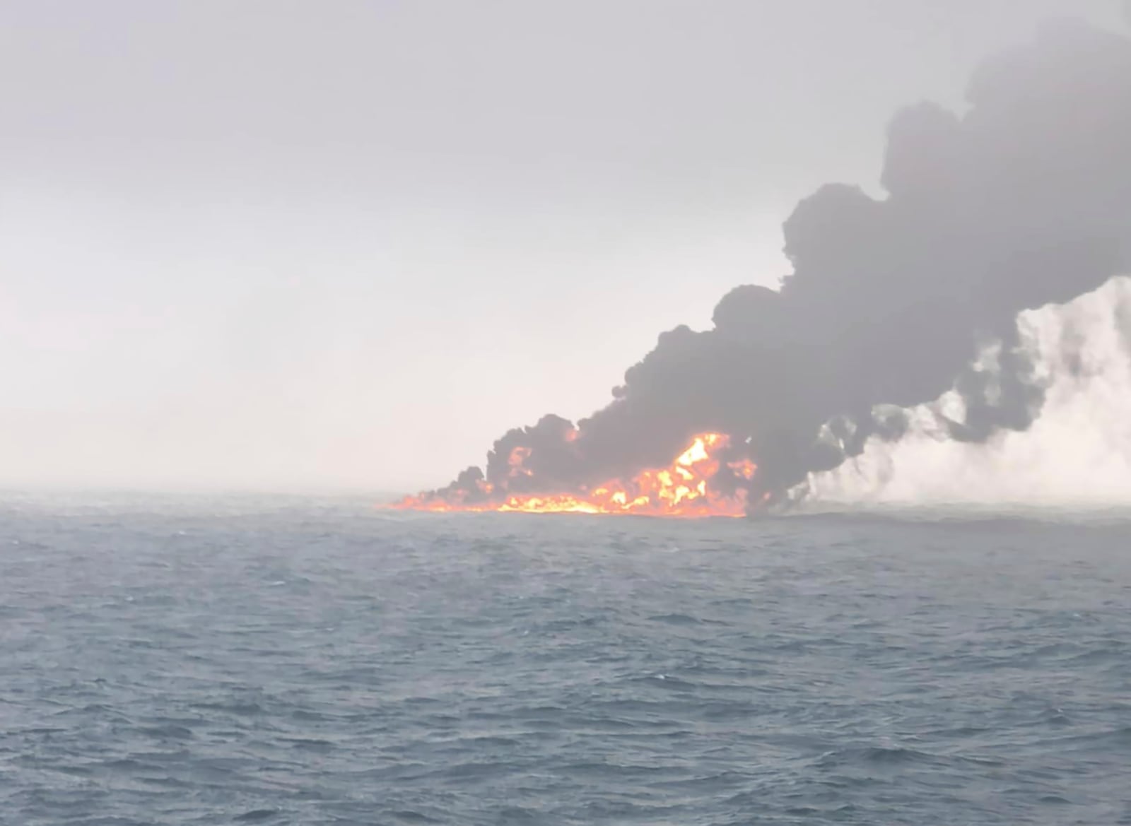 This image provided by Bartek Śmiałek shows smoke billowing from a vessel after a cargo ship hit a tanker carrying jet fuel off eastern England on Monday, March 10, 2025 setting both ablaze and sending fuel pouring into the North Sea. (Bartek Śmiałek via AP)