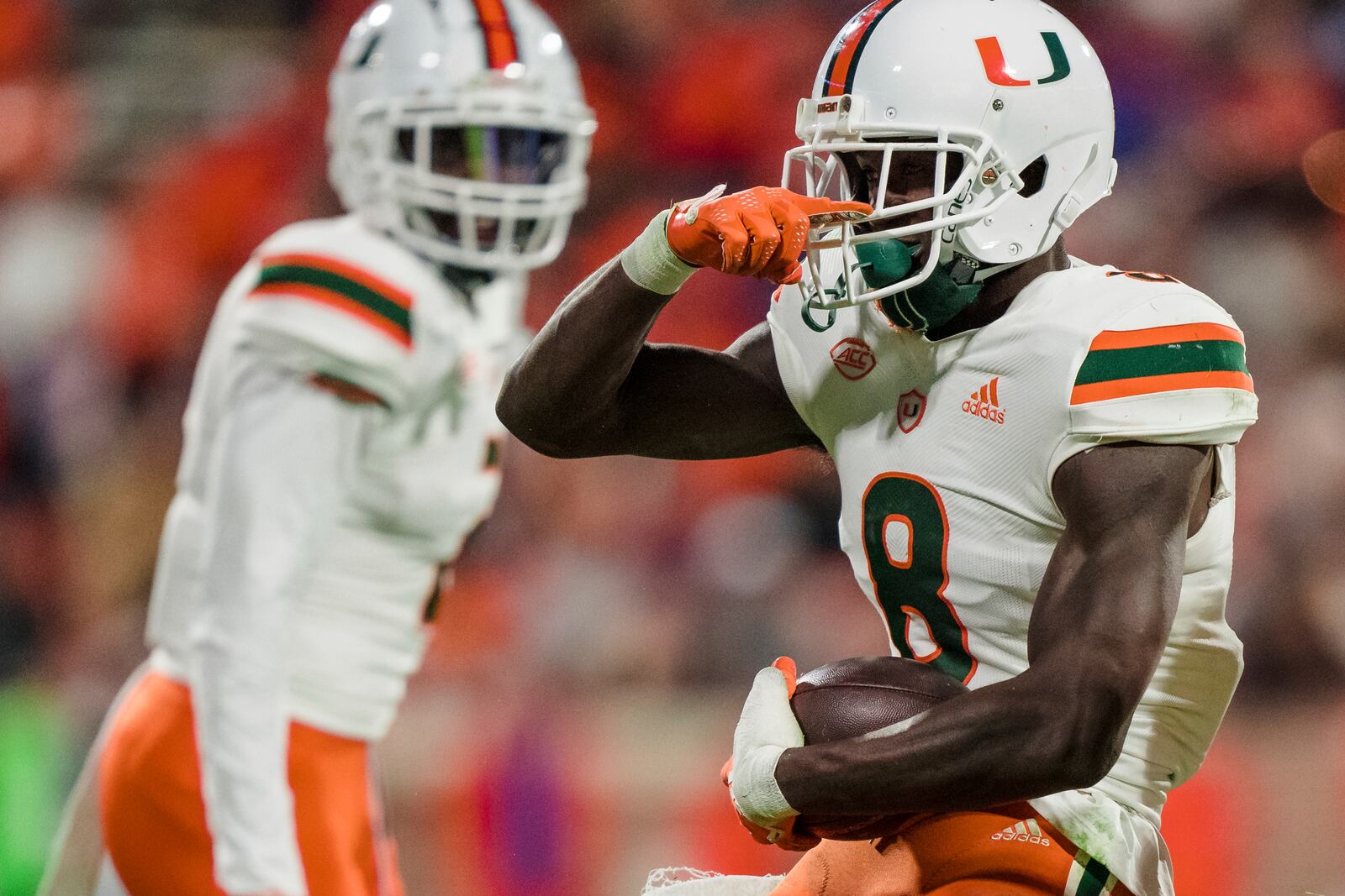 Miami cornerback DJ Ivey (8) reacts after making an interception in the second half of the team's NCAA college football game against Clemson on Saturday, Nov. 19, 2022, in Clemson, S.C. (AP Photo/Jacob Kupferman)