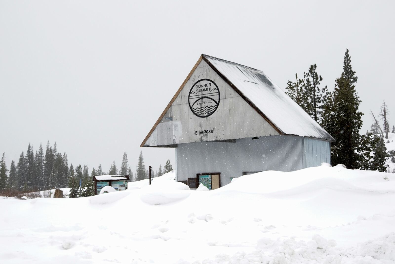 Snow accumulates in front of a welcome center during a storm Thursday, Nov. 21, 2024, on Donner Summit near Truckee, Calif. (AP Photo/Brooke Hess-Homeier)