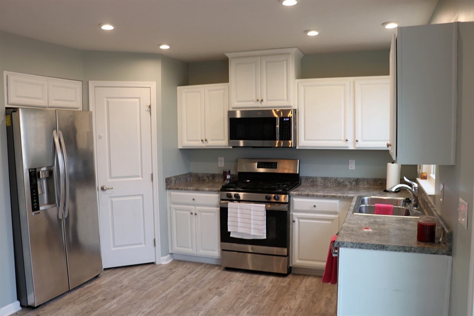 The U-shaped kitchen has a window above the double sink and a corner pantry closet.