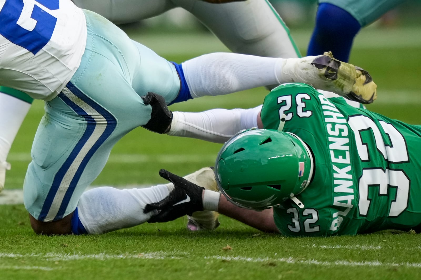 Philadelphia Eagles safety Reed Blankenship, right, grabs at Dallas Cowboys running back Rico Dowdle while tackling him during the second half of an NFL football game, Sunday, Dec. 29, 2024, in Philadelphia. (AP Photo/Matt Slocum)