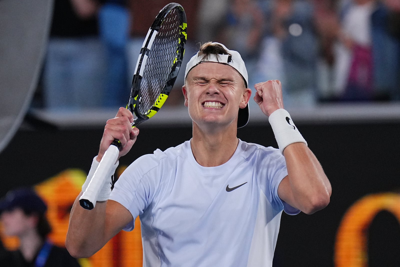 Holger Rune of Denmark celebrates after defeating Miomir Kecmanovic of Serbia in their third round match at the Australian Open tennis championship in Melbourne, Australia, Sunday, Jan. 19, 2025. (AP Photo/Vincent Thian)