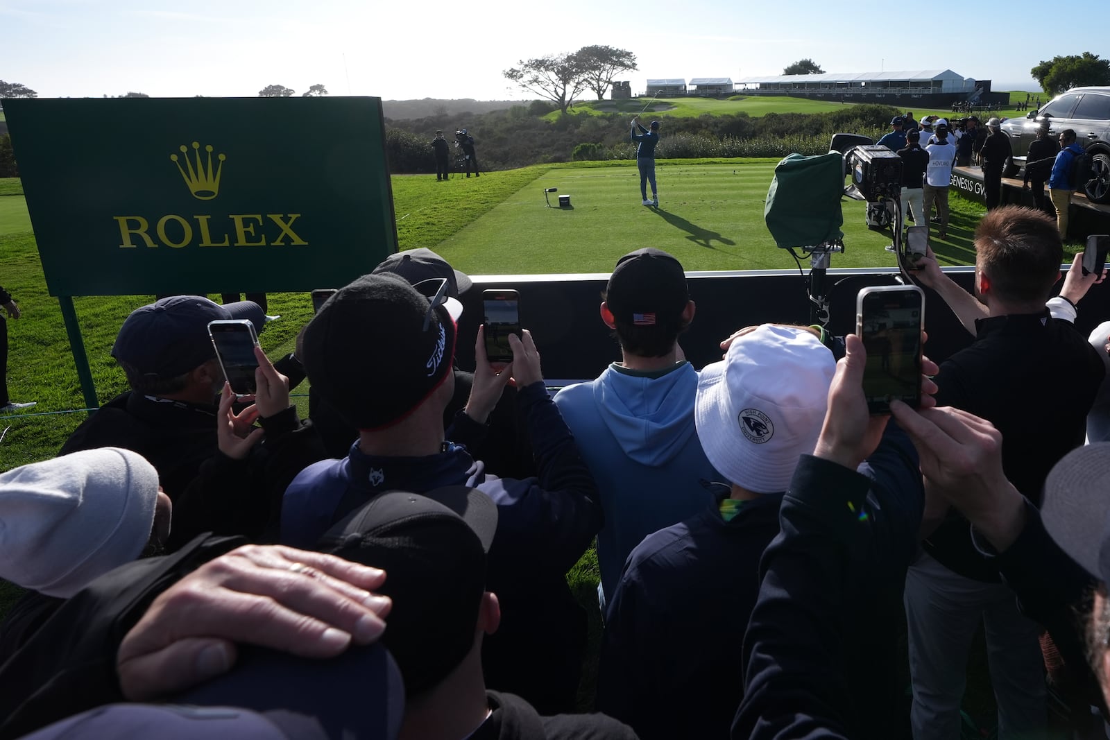 Fans watch Rory McIlroy, of Northern Ireland, hit his tee shot on the 16th hole of the South Course at Torrey Pines during the second round of the Genesis Invitational golf tournament Friday, Feb. 14, 2025, in San Diego. (AP Photo/Gregory Bull)