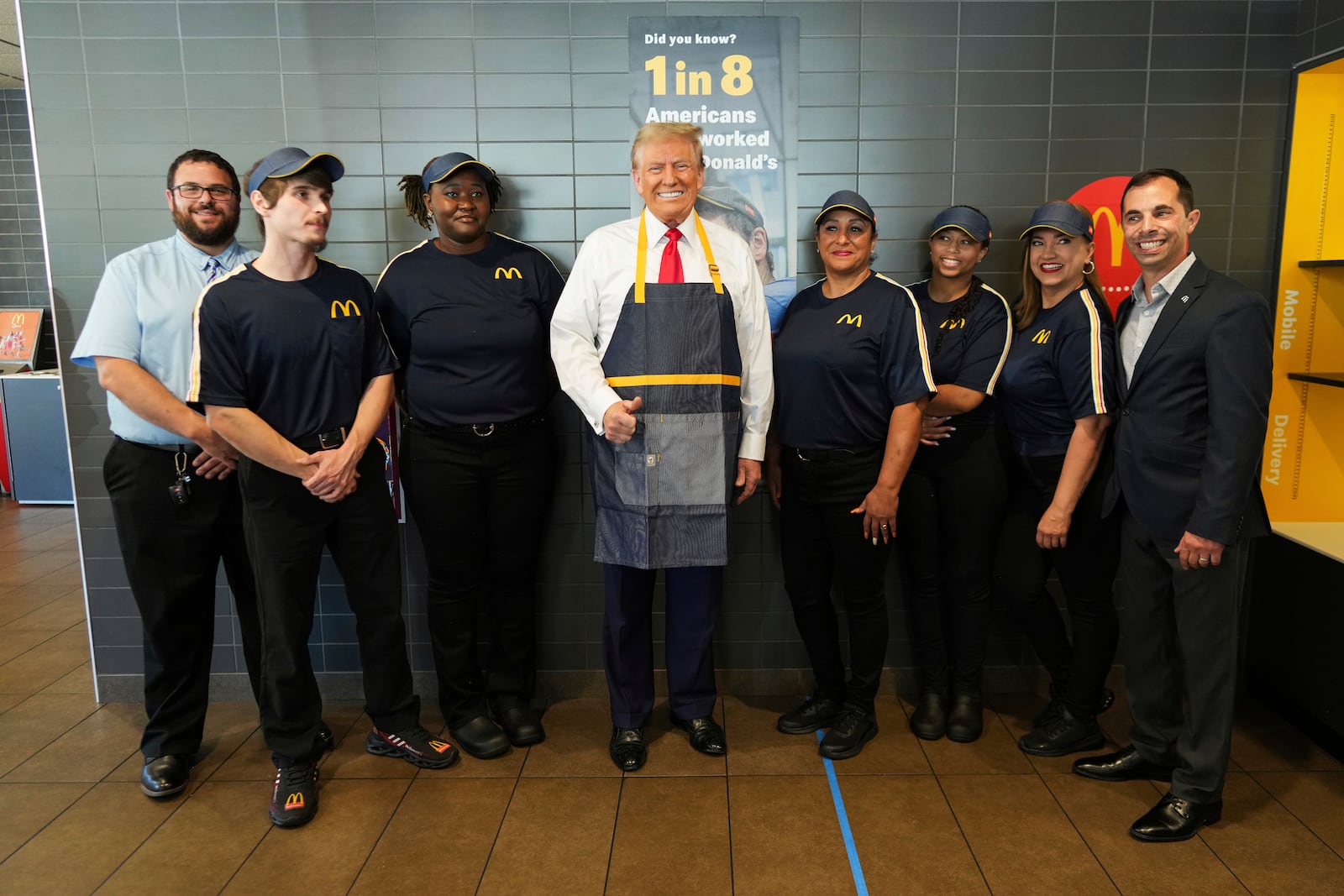 Republican presidential nominee former President Donald Trump poses with employees during a visit to McDonald's in Feasterville-Trevose, Pa., Sunday, Oct. 20, 2024. (Doug Mills/The New York Times via AP, Pool)