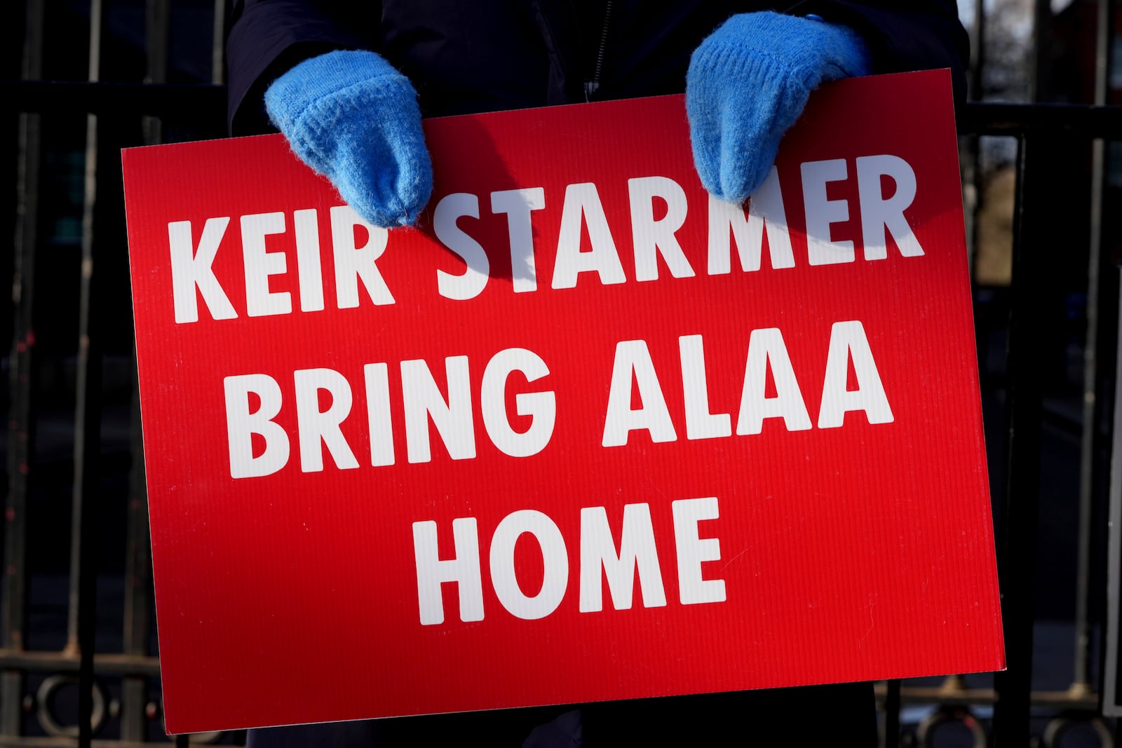 Leila Soueif holds a banner, she has been on hunger strike for more than 129 days seeking the release of her son Alaa Abdel Fattah from prison in Egypt, outside Downing Street in London, Wednesday, Feb. 5, 2025. (AP Photo/Kirsty Wigglesworth)