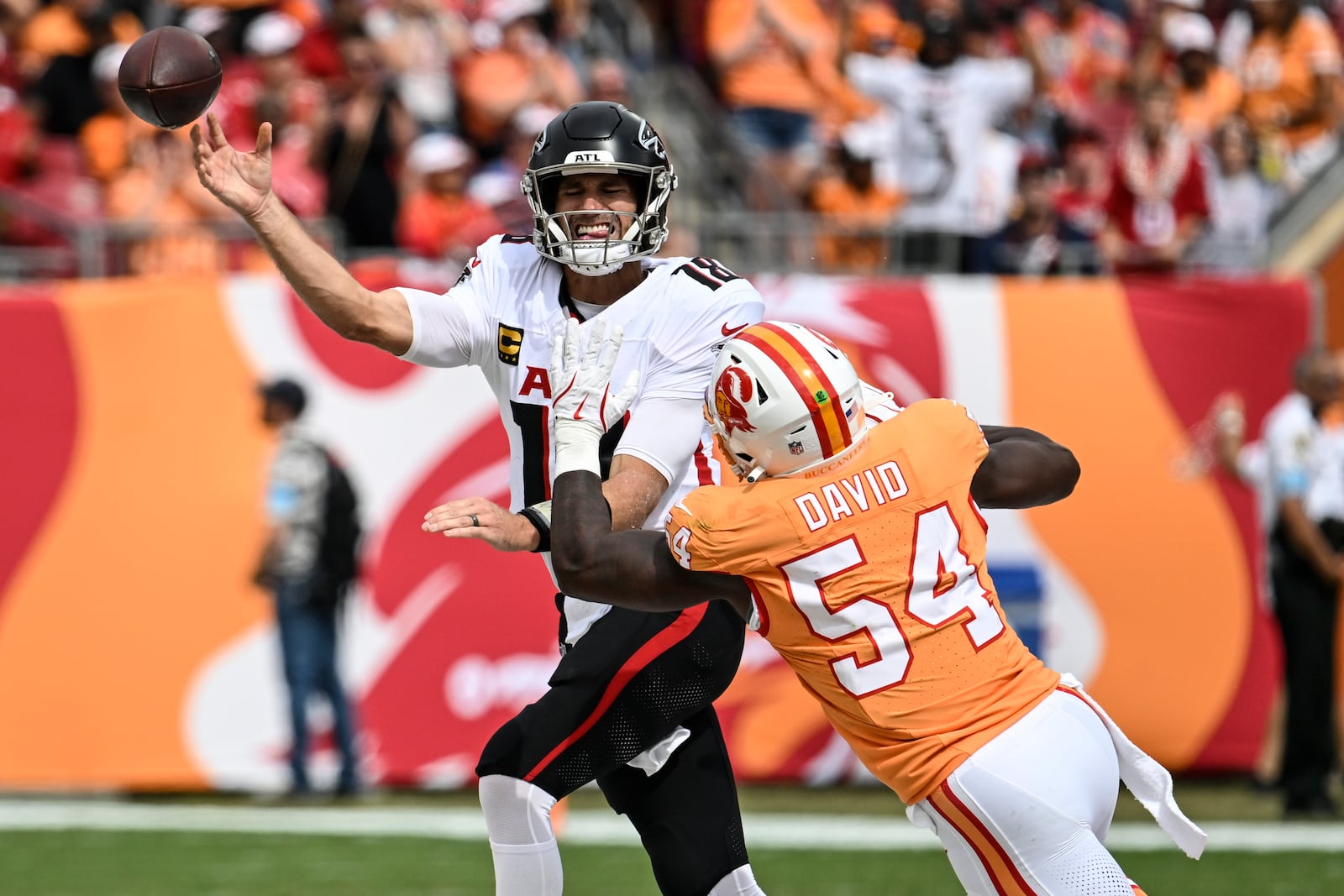 Tampa Bay Buccaneers linebacker Lavonte David (54) pressures Atlanta Falcons quarterback Kirk Cousins (18) during the first half of an NFL football game, Sunday, Oct. 27, 2024, in Tampa. (AP Photo/Jason Behnken)