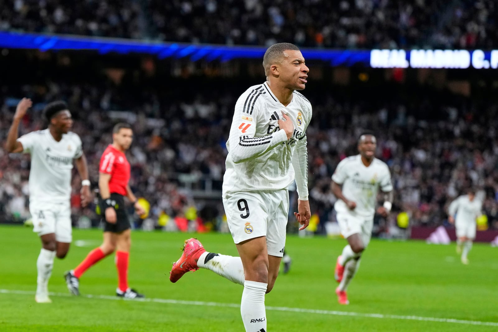 Real Madrid's Kylian Mbappe celebrates after scoring his side's opening goal during the Spanish La Liga soccer match between Real Madrid and Rayo Vallecano at the Santiago Bernabeu stadium in Madrid, Spain, Sunday, March 9, 2025. (AP Photo/Manu Fernandez)