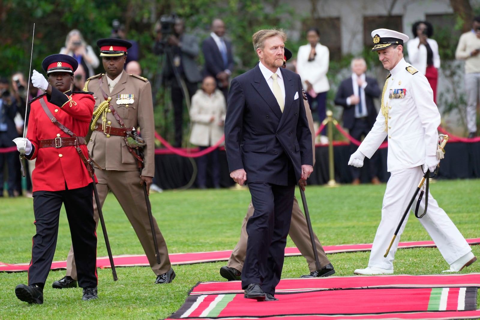 King Willem-Alexander of the Netherlands reviews the honor guard after arriving to meet with Kenya's President William Ruto at State House in Nairobi, Kenya, Tuesday, March 18, 2025. (AP Photo/Brian Inganga)