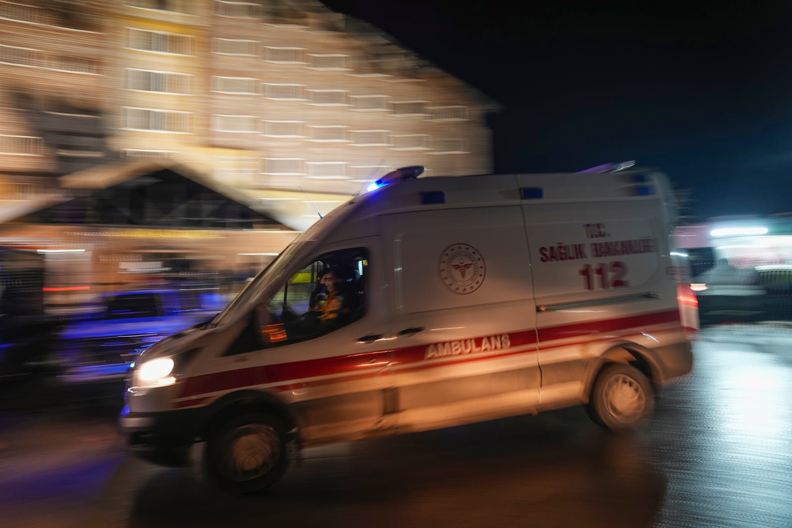 An ambulance leaves the scene where a fire broke out at a hotel in the ski resort of Kartalkaya, located in Bolu province, northwest Turkey, on Tuesday, Jan. 21, 2025. (AP Photo/Francisco Seco)