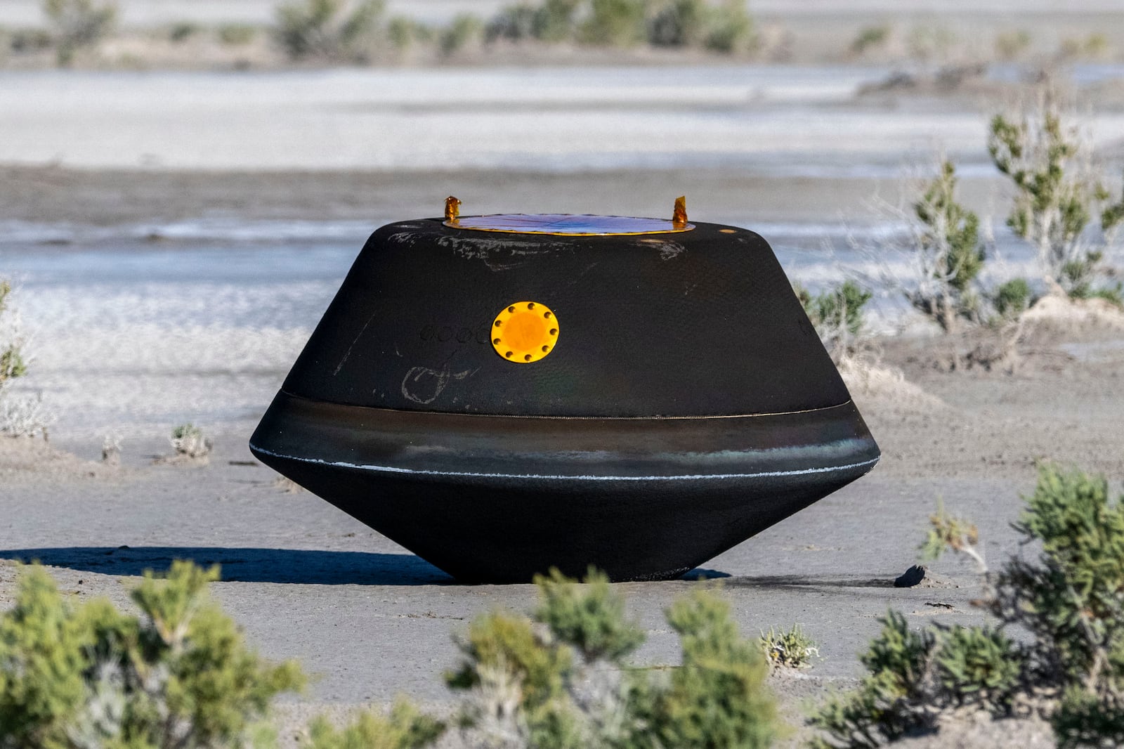 FILE - In this photo provided by NASA, the sample return capsule from NASA's Osiris-Rex mission lies on the ground shortly after touching down in the desert, at the Department of Defense's Utah Test and Training Range on Sept. 24, 2023. (Keegan Barber/NASA via AP, file)