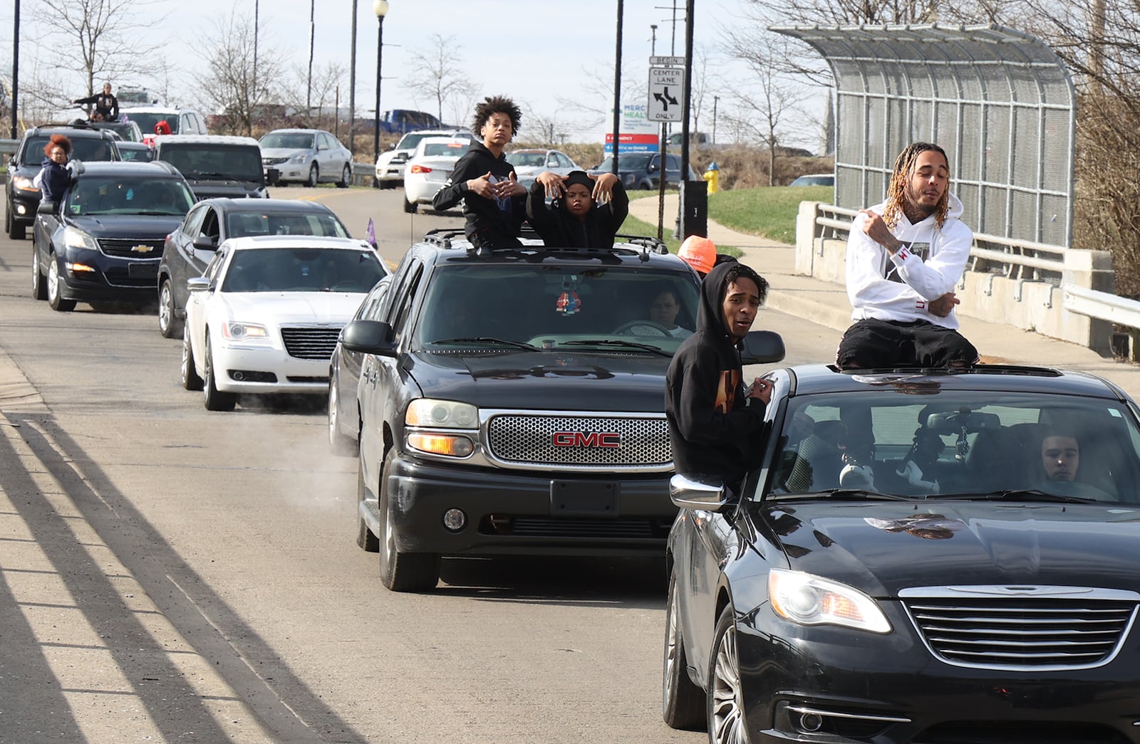 A long procession of cars slowly follows a horse-drawn hearse, carrying the body of Melvin Belle, 16, through the streets of Springfield to Ferncliff Cemetery Tuesday, March 29, 2022. Belle was shot and killed last week on South Yellow Springs Street. BILL LACKEY/STAFF