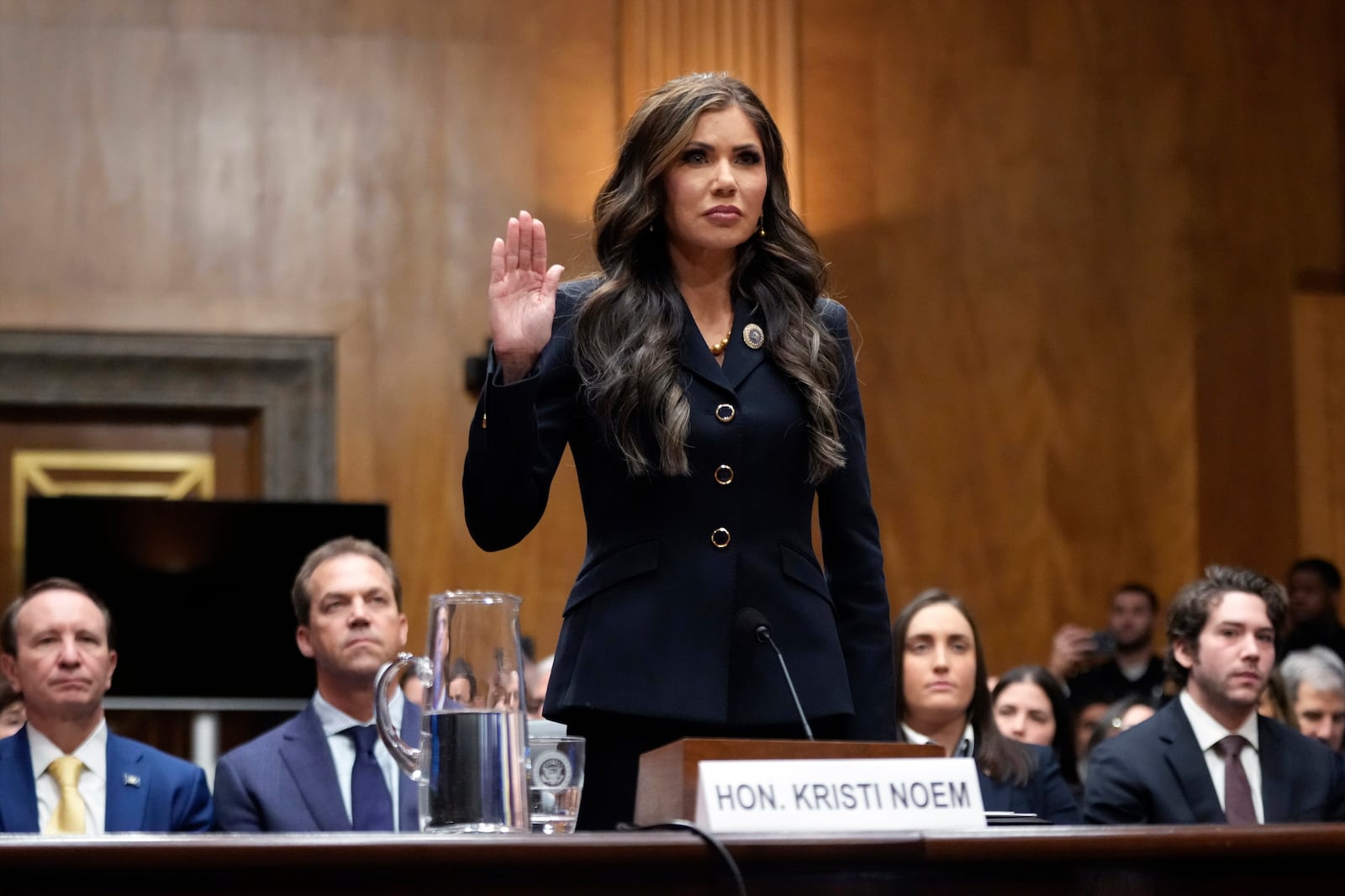 FILE - South Dakota Gov. Kristi Noem, President-elect Donald Trump's pick to be Secretary of Homeland Security, is sworn in before the Senate Homeland Security and Governmental Affairs Committee for her confirmation hearing, at the Capitol in Washington, Jan. 17, 2025. (AP Photo/Ben Curtis, File)