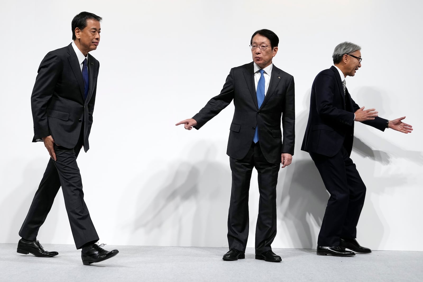 Nissan Chief Executive Makoto Uchida, left, Takao Kato CEO of Mitsubishi Motors, center, and Honda Chief Executive Toshihiro Mibe, right, leave after a joint news conference in Tokyo, Japan, Monday, Dec. 23, 2024. (AP Photo/Eugene Hoshiko)