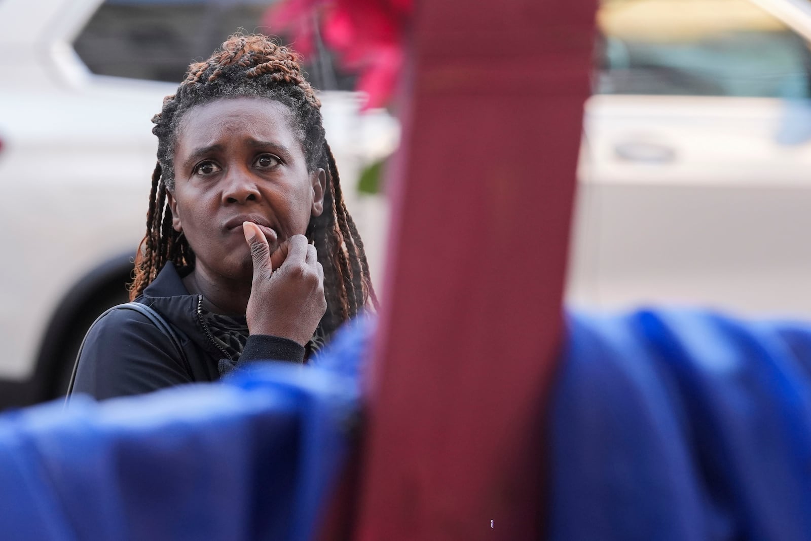 Katriel Faith Gibson, who lives nearby, reacts as she visits a memorial on Canal Street for the victims of a deadly truck attack on New Year's Day in New Orleans, Friday, Jan. 3, 2025. (AP Photo/Gerald Herbert)