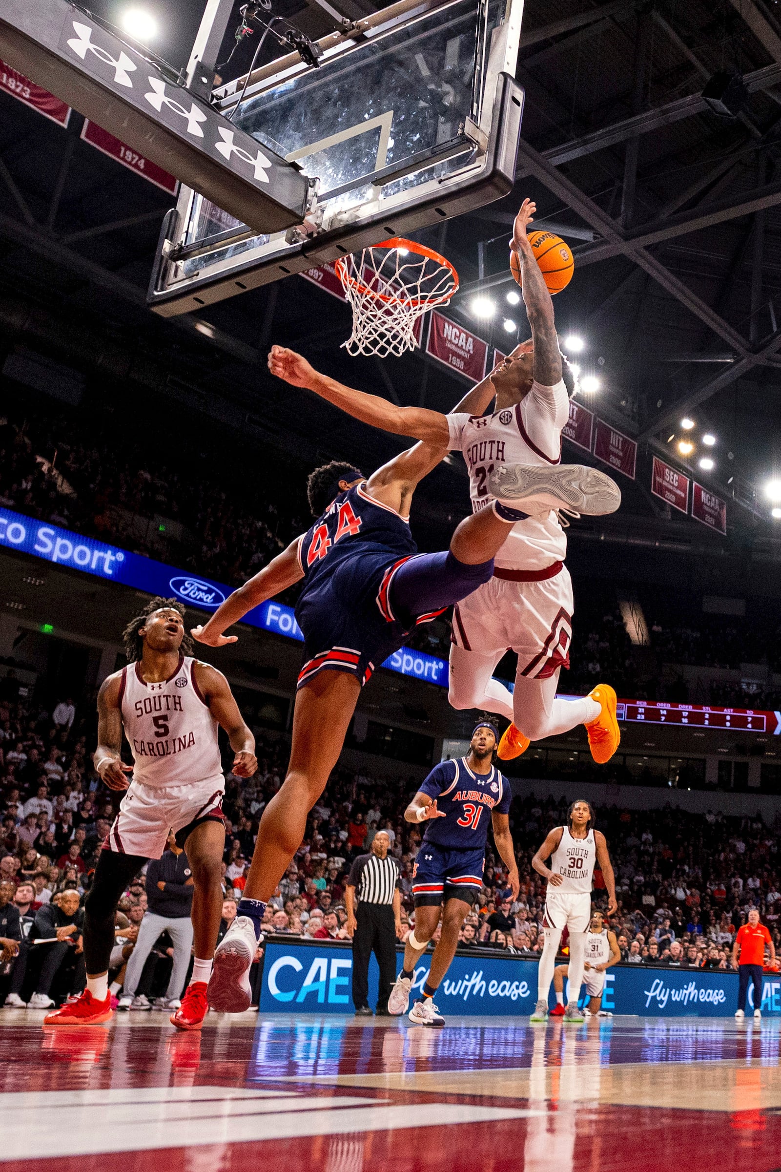 South Carolina guard Arden Conyers (21) is fouled by Auburn center Dylan Cardwell (44) as he shoots during the second half of an NCAA college basketball game on Saturday, Jan. 11, 2025, in Columbia, SC (AP Photo/Scott Kinser)