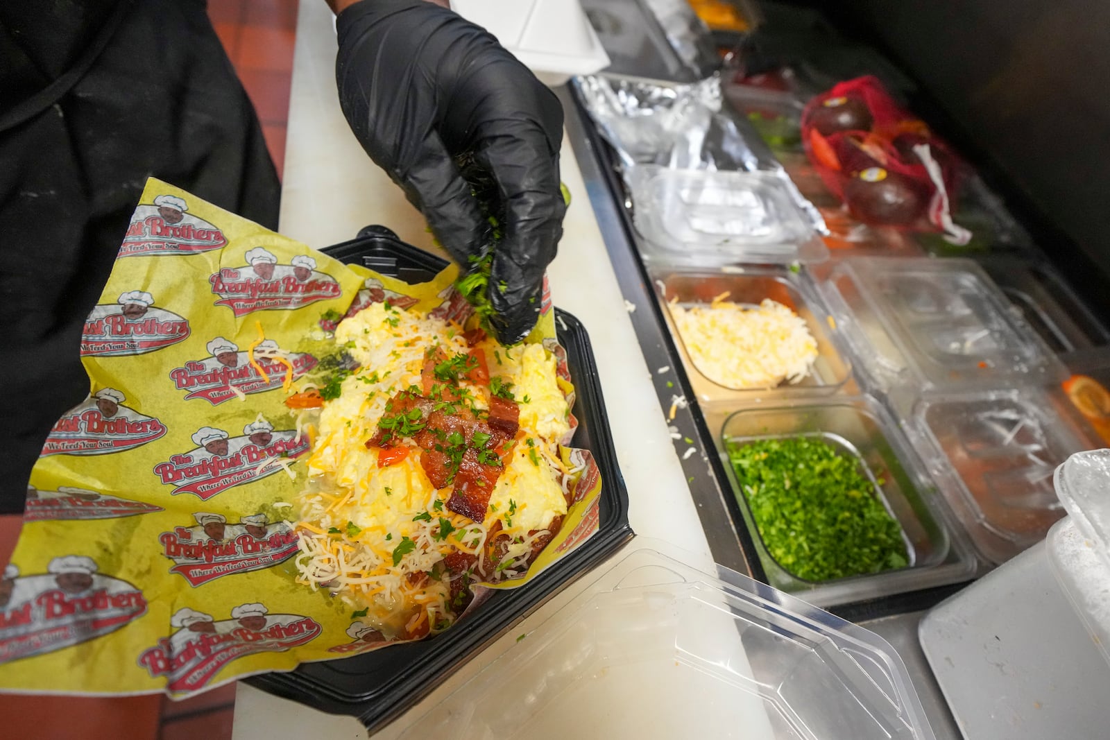 Johkiya Pierre prepares a fresh omelette at The Breakfast Brothers restaurant, Wednesday, Feb. 12, 2025, in Arlington, Texas. (AP Photo/Julio Cortez)