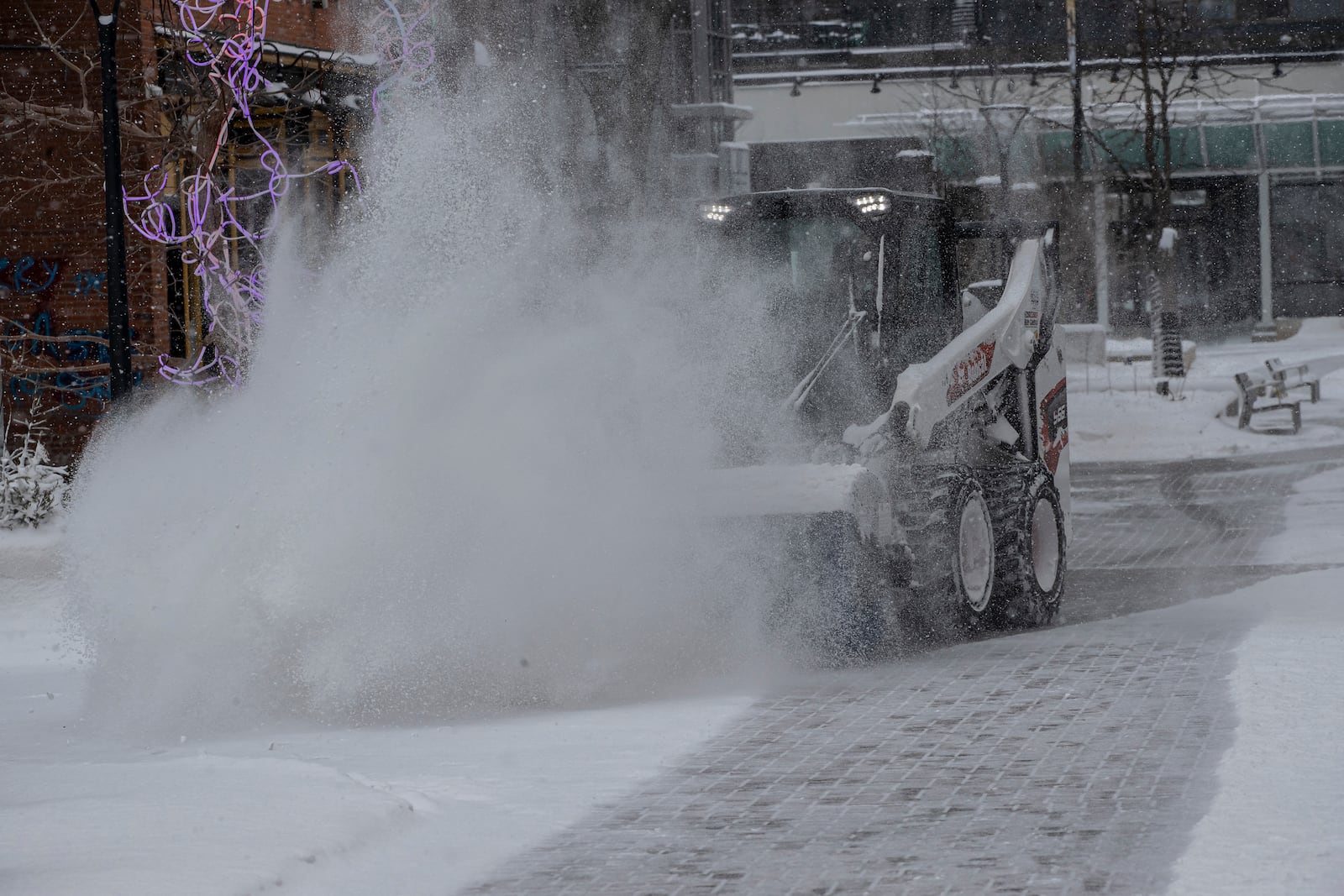 City workers clear snow from the pedestrian mall in Iowa City, Iowa on Wednesday, Feb. 12, 2025. (Nick Rohlman/The Gazette)