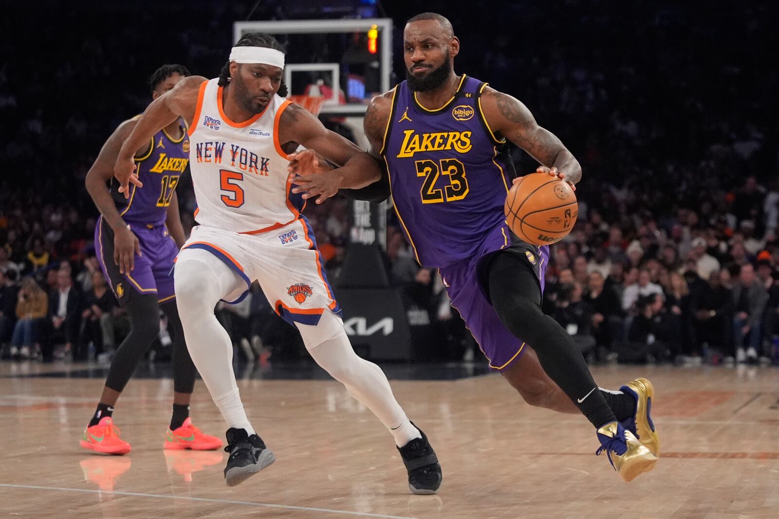 Los Angeles Lakers' LeBron James (23) drives past New York Knicks' Precious Achiuwa (5) during the second half of an NBA basketball game Saturday, Feb. 1, 2025, in New York. (AP Photo/Frank Franklin II)