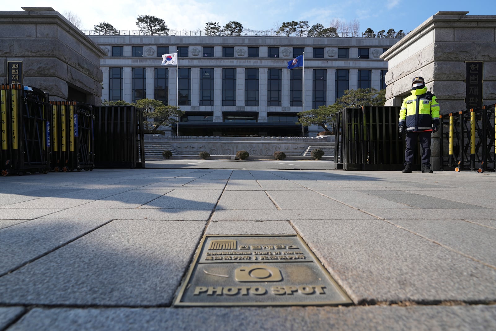 A South Korean police officer stands in front of the Constitutional Court in Seoul, South Korea, Tuesday, Dec. 17, 2024. (AP Photo/Lee Jin-man)