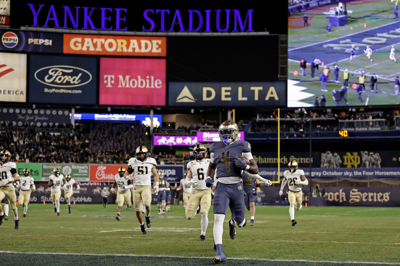 Notre Dame running back Jeremiyah Love (4) rushes for a touchdown past Army safety Max DiDomenico (6) during the second half of an NCAA college football game at Yankee Stadium, Saturday, Nov. 23, 2024, in New York. (AP Photo/Adam Hunger)