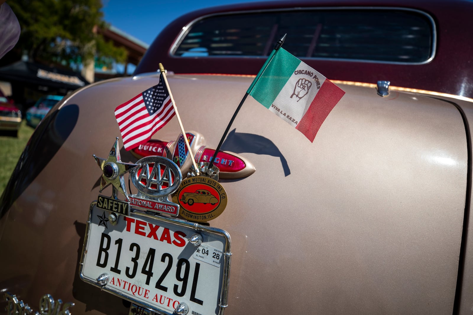 American and Mexican flags decorate a vintage car during a lowrider exhibition for the 20th anniversary of Lincoln Park in El Paso, Texas, Sunday, Sept. 22, 2024. (AP Photo/Andrés Leighton)