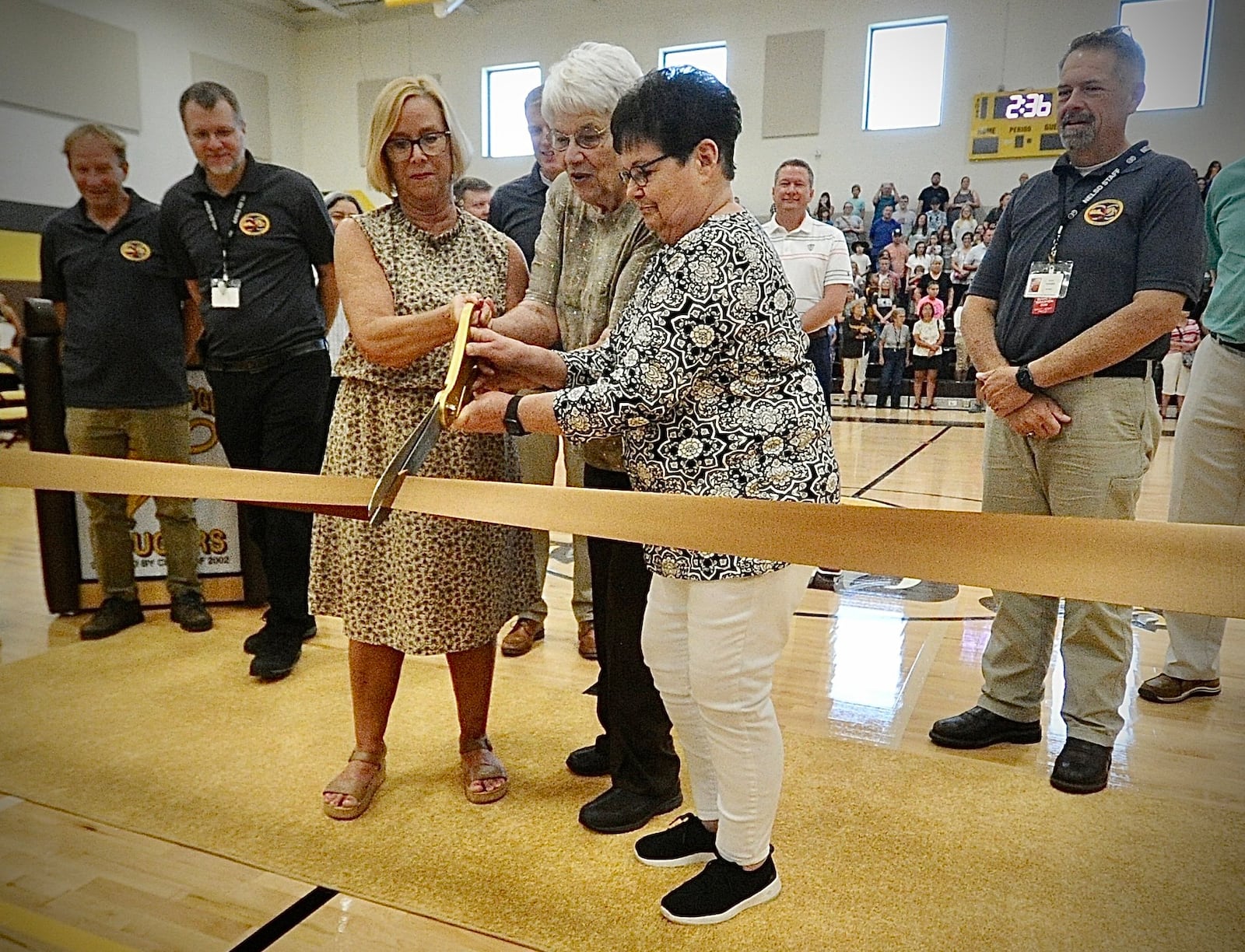 From left, Lori Saunders, Emily Spriggs and Janet Flora cut the ribbon for the new Kenton Ridge school in August 19, 2023. MARSHALL GORBY/STAFF