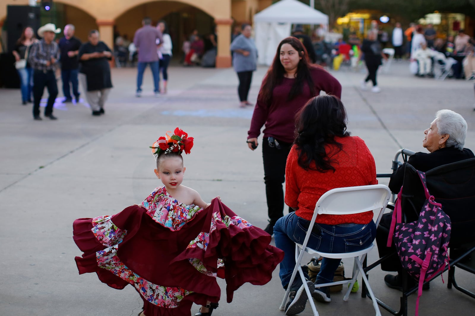 FILE - People gather in Guadalupe, Ariz., during the celebration of the town's 45th year since it was incorporated, on Feb. 8, 2020. (AP Photo/Dario Lopez-MIlls, File)