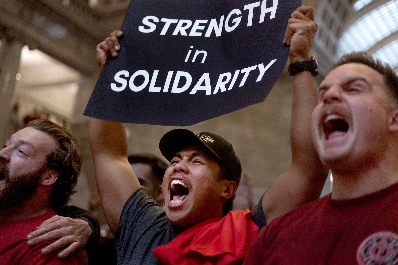 Professional firefighters of Utah members Donavan Minutes, left, Branden Cresencia and Bennett Lloyd chant during the Solidarity Rally in opposition to "HB 267 Public Sector Labor Union Amendments" at the Capitol in Salt Lake City, Utah, on Friday, Feb. 7, 2025. (Laura Seitz/The Deseret News via AP)