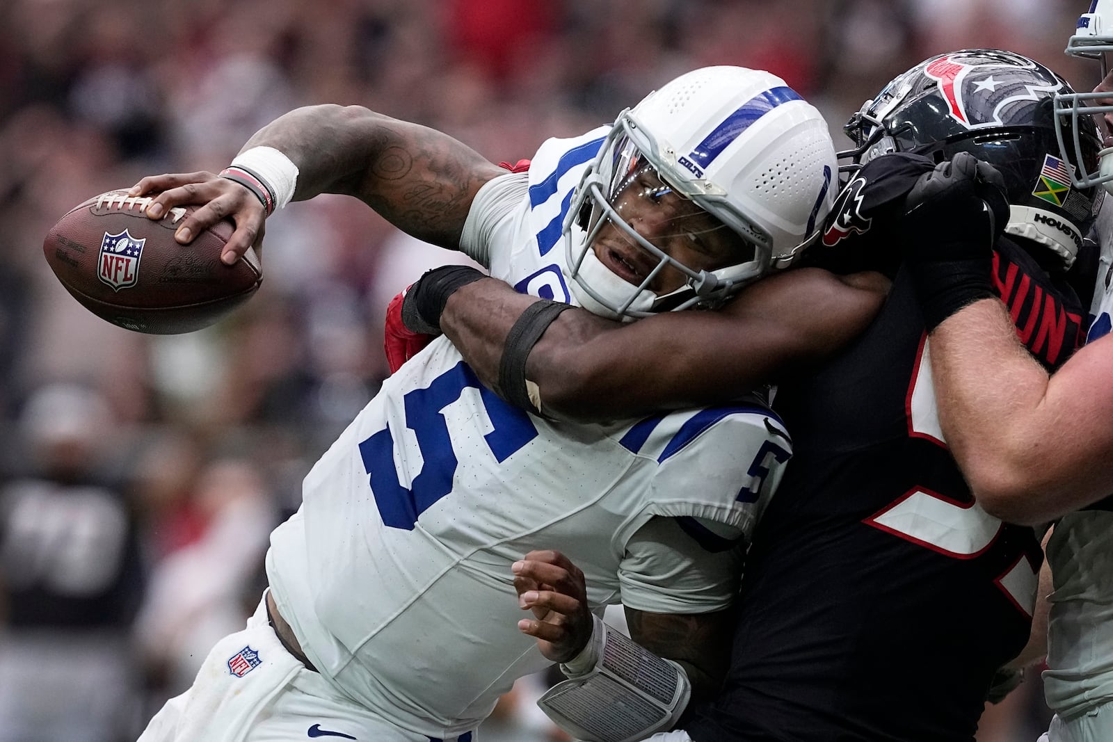 Indianapolis Colts quarterback Anthony Richardson (5) is sacked by Houston Texans defensive end Danielle Hunter (55) during the second half of an NFL football game, Sunday, Oct. 27, 2024, in Houston. (AP Photo/Tony Gutierrez)