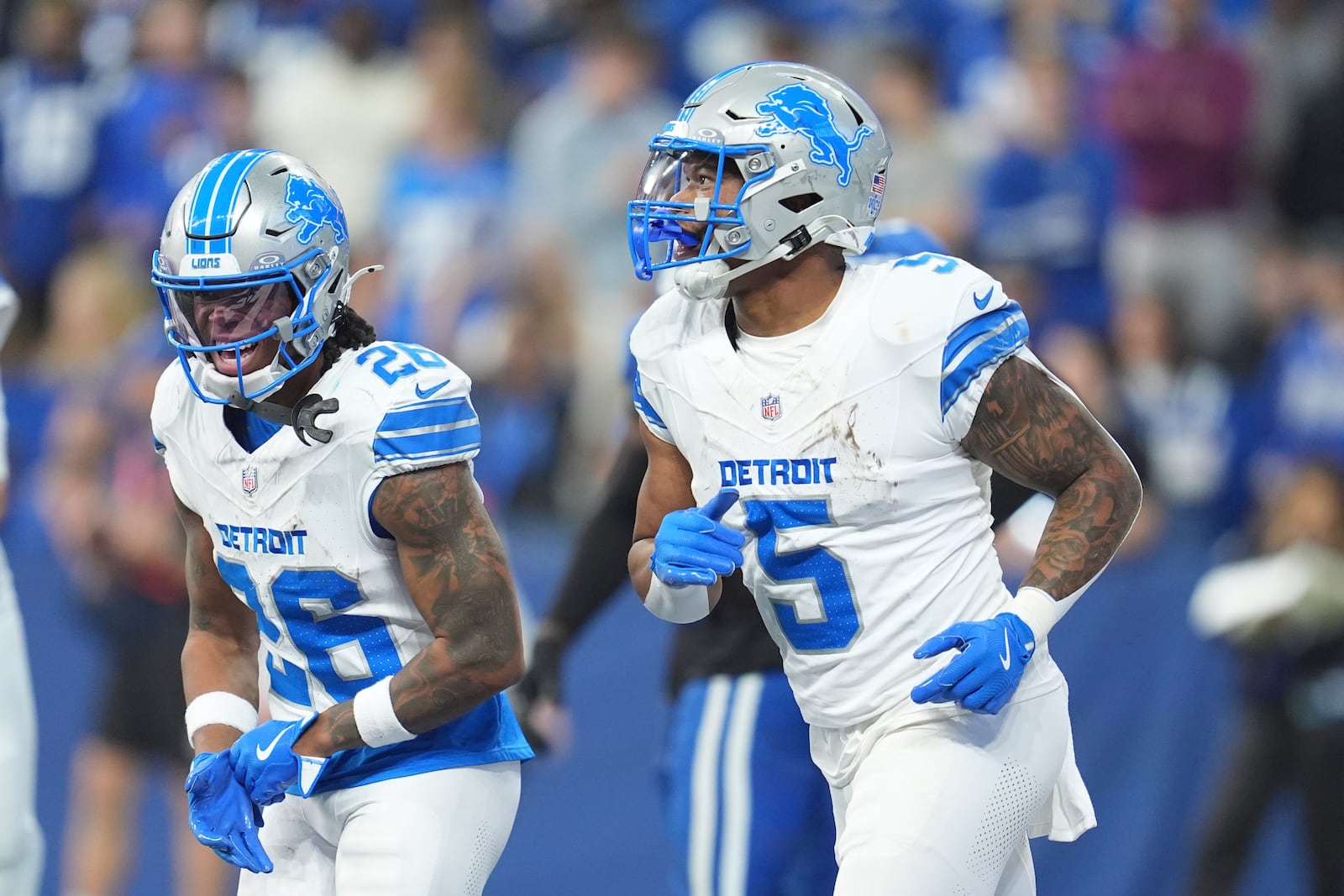 Detroit Lions running back David Montgomery (5) and running back Jahmyr Gibbs (26) celebrate after Montgomery's 6-yard rushing touchdown during the first half of an NFL football game against the Indianapolis Colts, Sunday, Nov. 24, 2024, in Indianapolis. (AP Photo/Michael Conroy)