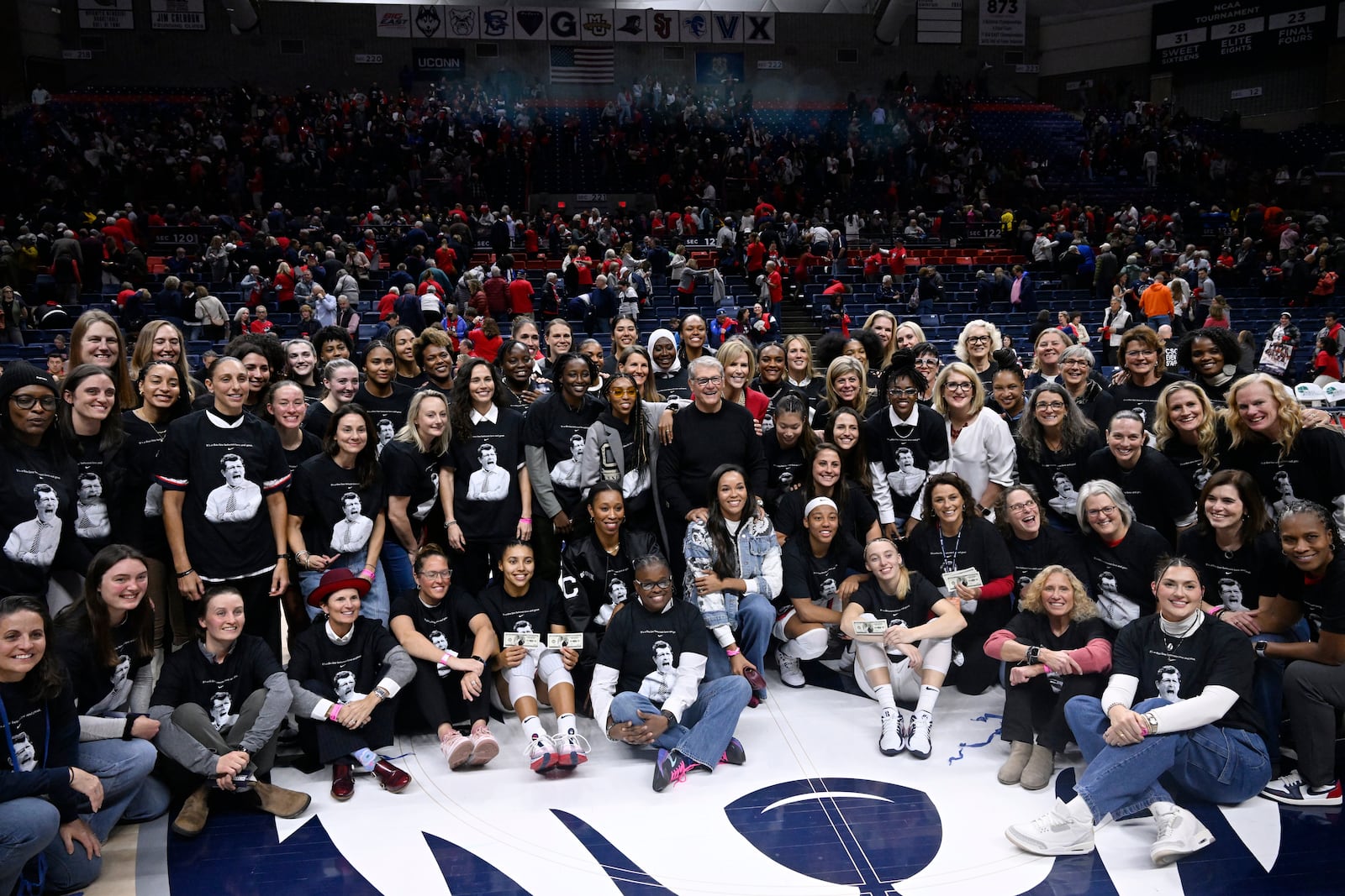 UConn head coach Geno Auriemma poses for a photograph with his players past and present and coaches as he is honored for the most wins in college basketball history, Wednesday, Nov. 20, 2024, in Storrs, Conn. (AP Photo/Jessica Hill)