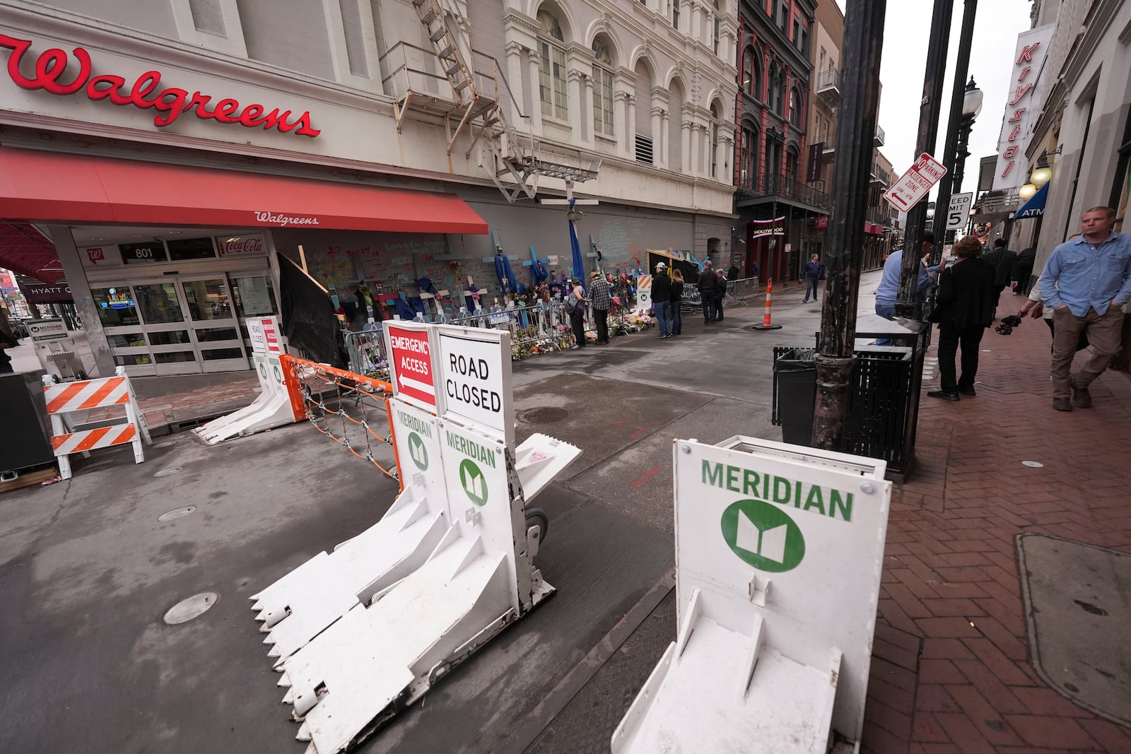 Newly installed security barriers are seen on Bourbon Street next to a memorial for victims of the Jan. 1 car attack ahead of the Super Bowl in New Orleans, Friday, Jan. 31, 2025. (AP Photo/Gerald Herbert)