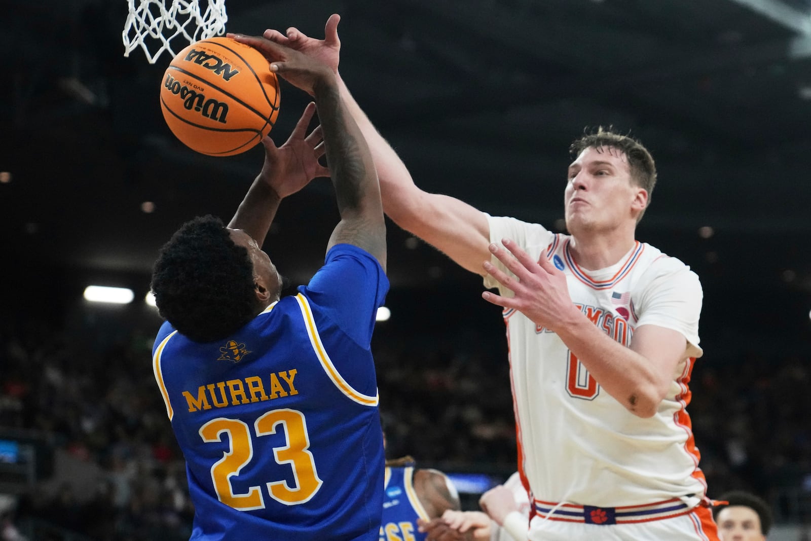 McNeese State guard Brandon Murray (23) battles for a rebound against Clemson center Viktor Lakhin (0) during the first half in the first round of the NCAA college basketball tournament, Thursday, March 20, 2025, in Providence, R.I. (AP Photo/Charles Krupa)