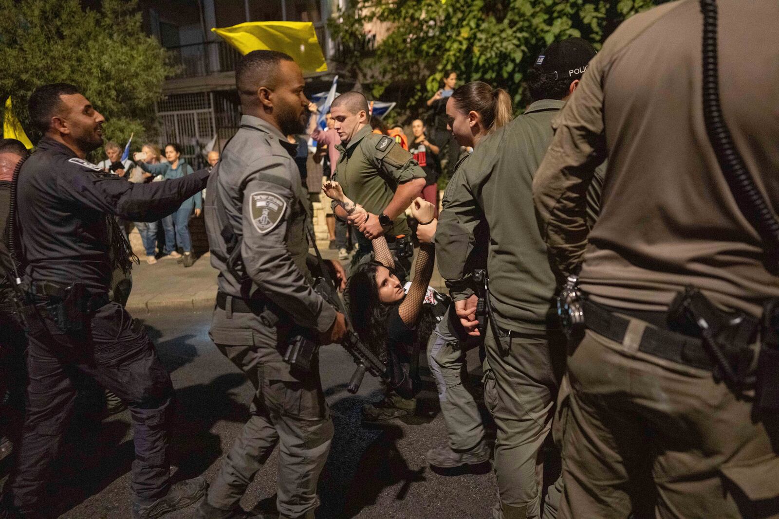 Police disperse people protesting against Prime Minister Benjamin Netanyahu's government and calling for the release of hostages held in the Gaza Strip by the Hamas militant group, near the Prime Minister's residence in Jerusalem, Monday, Oct. 28, 2024. (AP Photo/Ohad Zwigenberg)