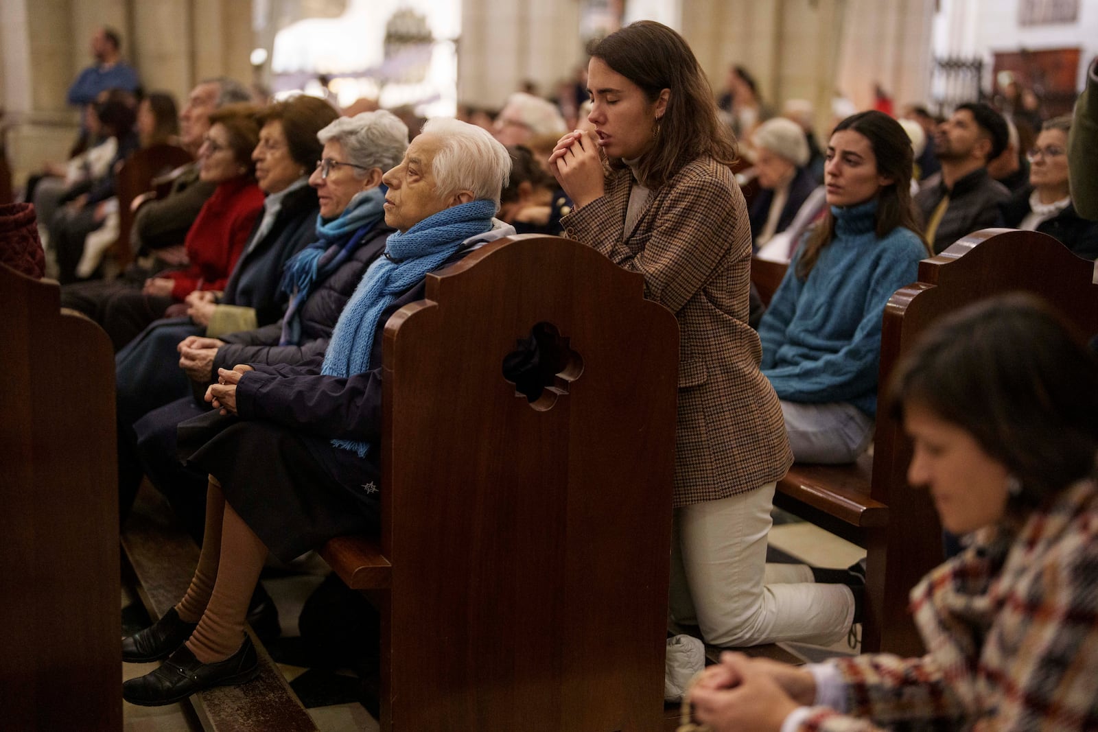 People pray for Pope Francis at Almudena Cathedral in Madrid, Spain, on Thursday, Feb. 27, 2025. (AP Photo/Manu Fernandez)