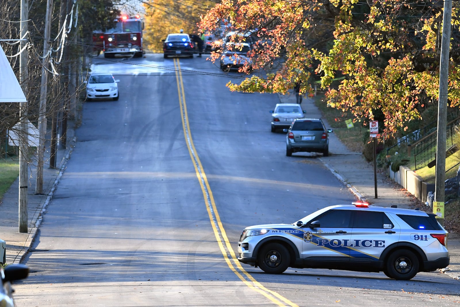 Members of the Louisville Metro Police and Louisville Fire Departments block access to Givaudan Sense Colour following an explosion at the facility in Louisville, Ky., Tuesday, Nov. 12, 2024. (AP Photo/Timothy D. Easley)