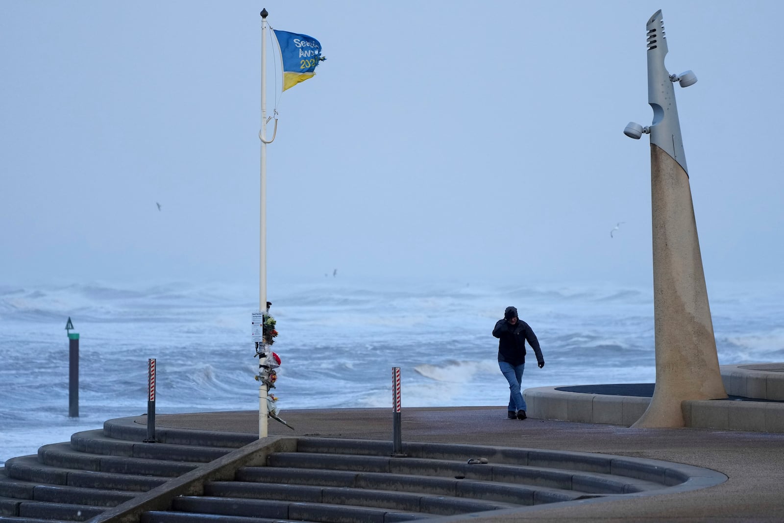 A man braves the wind as storm Eowyn hits the country in Cleveleys, near Blackpool, England, Friday, Jan. 24, 2025.(AP Photo/Jon Super)