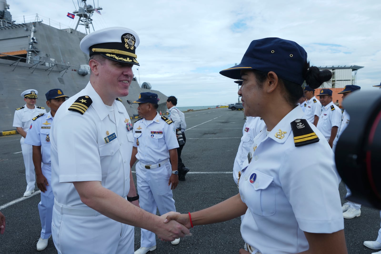 Daniel A. Sledz, left, commanding officer of USS Savannah, shakes hands with a Cambodian naval staff member as it arrives for a port call at Sihanoukville port, Cambodia, Monday, Dec. 16, 2024. (AP Photo/Heng Sinith)