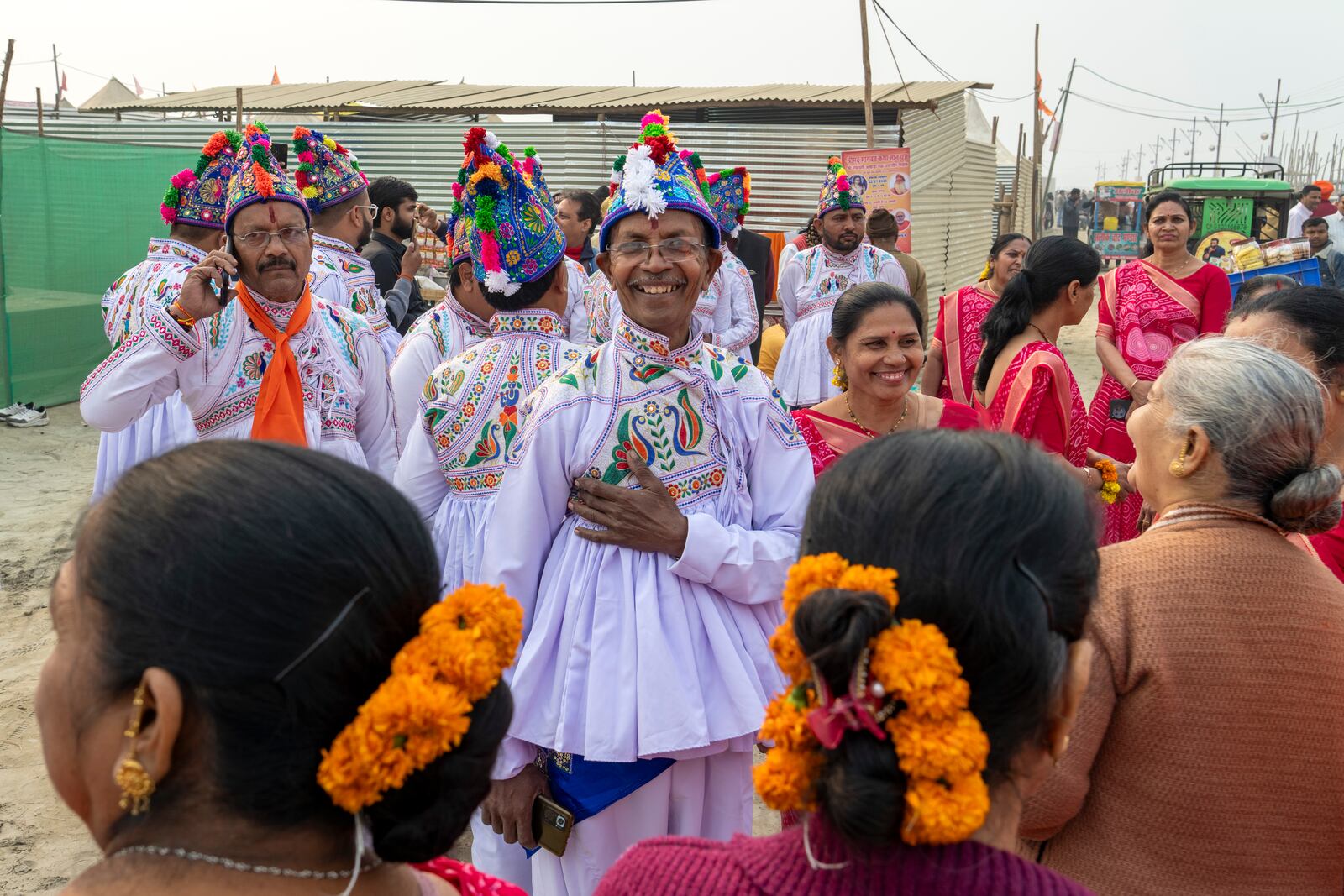 Hindu devotees wearing the ceremonial costume of the Kathiawar region in Gujarat state, sing hymns at the confluence of the Ganges, the Yamuna and the mythical Saraswati rivers, a day before the official beginning of the 45-day-long Maha Kumbh festival, in Prayagraj, India, Sunday, Jan. 12, 2025. (AP Photo/Ashwini Bhatia)