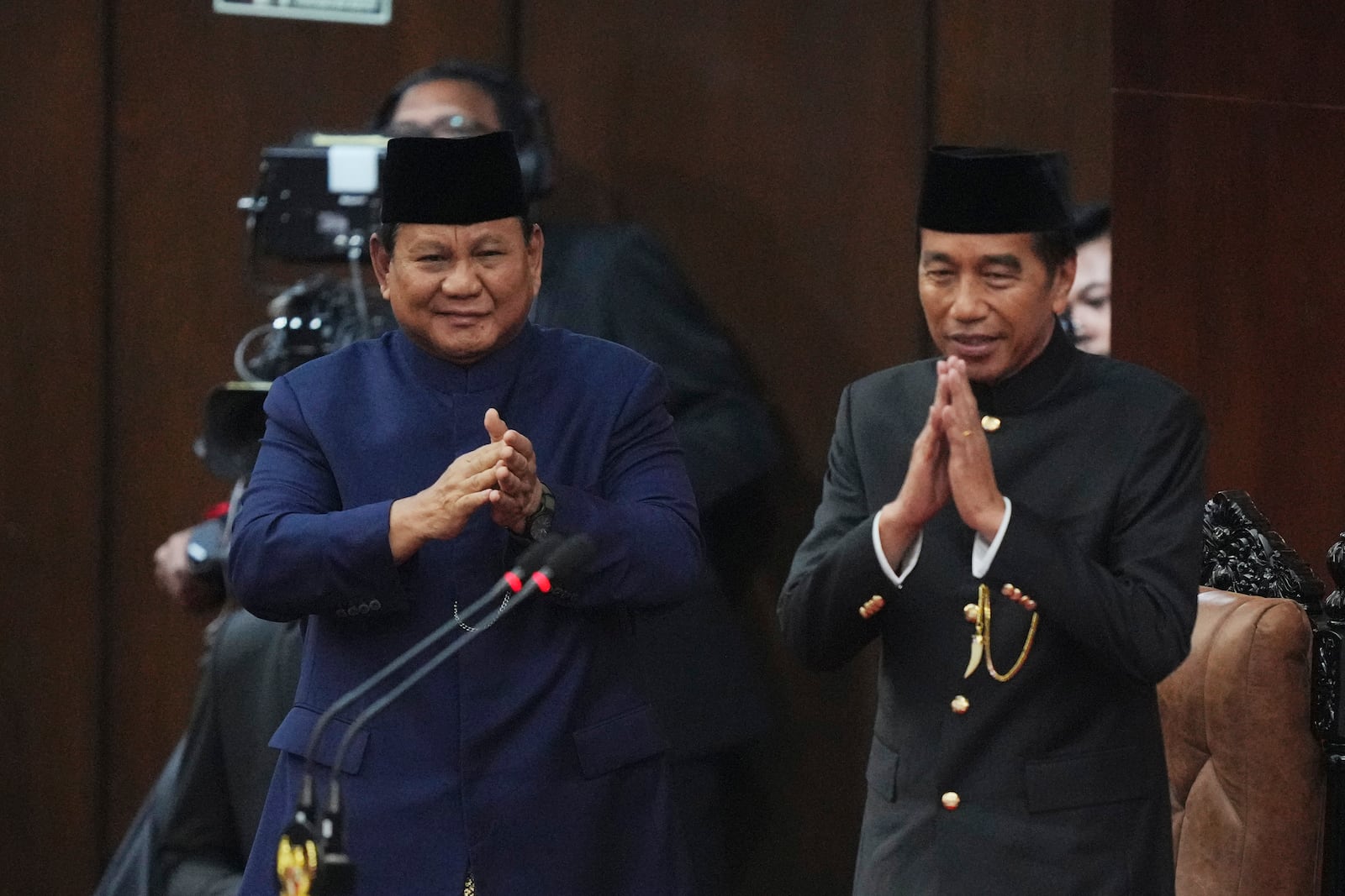 Indonesia's newly-inaugurated Indonesian President Prabowo Subianto, left, and former Indonesian President Joko Widodo salute during the presidential inauguration ceremony at the Parliament building in Jakarta, Indonesia, Sunday, Oct. 20, 2024. (AP Photo/Tatan Syuflana)