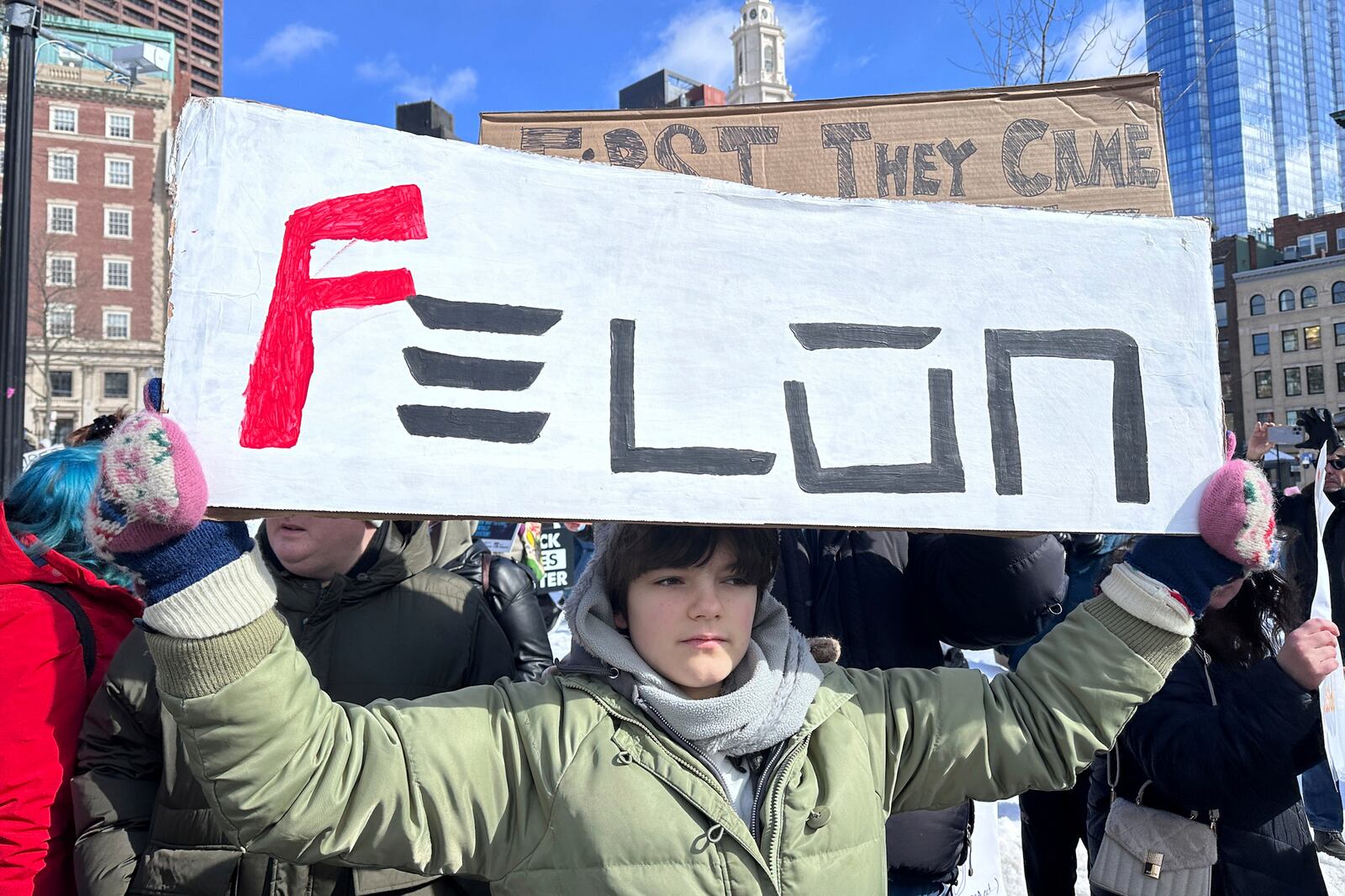 Demonstrators join more than a thousand people protesting the policies of the Trump administration marched from the Boston Common past City Hall to the North End, Monday, Feb. 17, 2025 in Boston. (AP/Michael Casey)